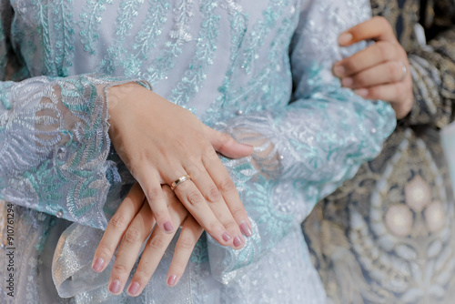 Close up of couple's hands. Newlyweds' hands with gold rings on their fingers.