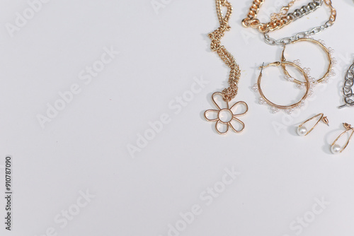 Gold and silver jewellery. Pastel Background