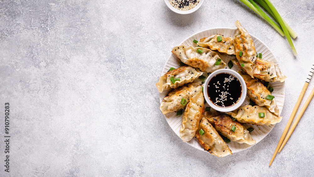 Fried dumplings gyoza with soy sauce, and chopsticks.