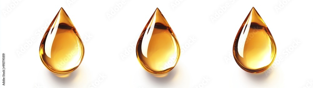 Fototapeta premium Three Golden Oil Drops on White Background