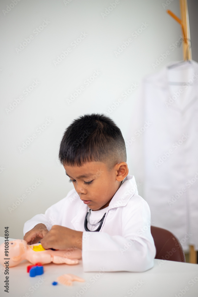 A young boy is playing with a doll in a doctor's office A young boy is playing with a doll in a doctor's office