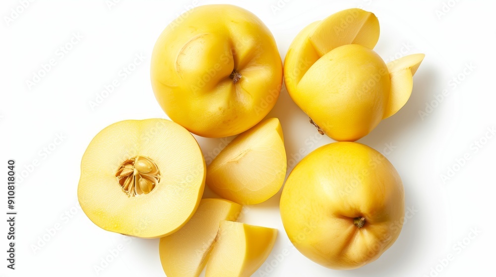 A selection of quince, both whole and sliced, arranged with precision. The rich golden hues stand out against the pure white background A selection of quince, both whole and sliced, arranged with precision. The rich golden hues stand out against the pure white background