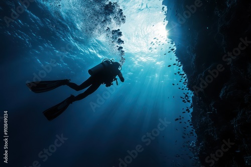 Wallpaper Mural Scuba diver exploring the ocean depths with light rays piercing through the water, illuminating the underwater scenery with marine life. Torontodigital.ca