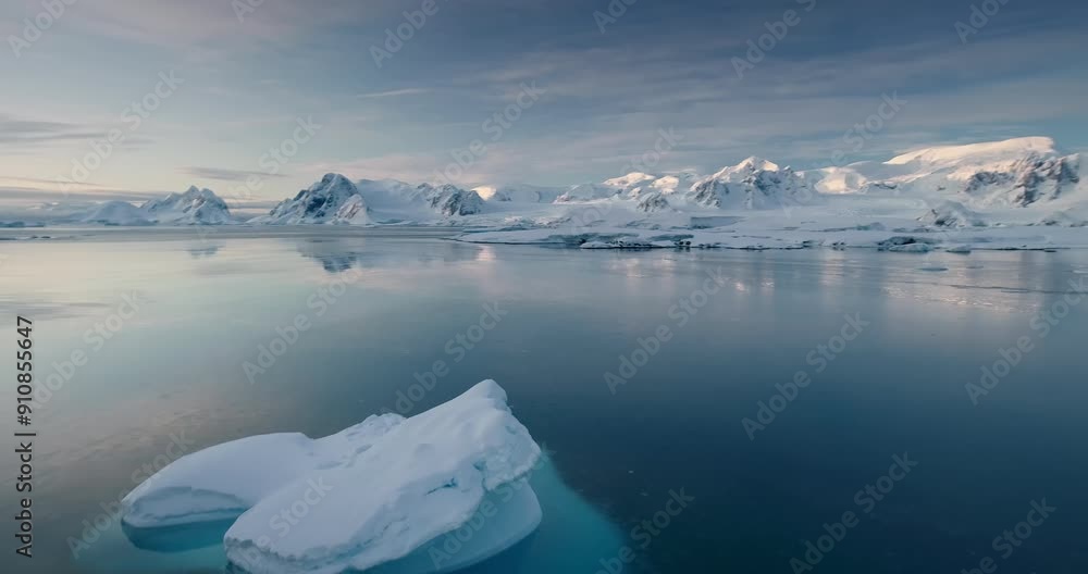 Arctic winter panorama. Melting glacier in blue ocean water, snow covered mountains in background. Iceberg float aerial. Antarctica travel and exploration. Environment ecology global warming concept Arctic winter panorama. Melting glacier in blue ocean water, snow covered mountains in background. Iceberg float aerial. Antarctica travel and exploration. Environment ecology global warming concept