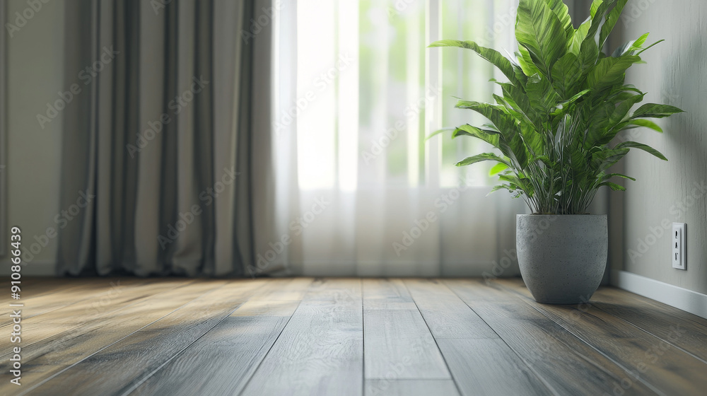 A wooden-floored room with gray curtains. A wall has a concealed white battery and thermostat. A big green plant in a gray pot sits on the floor. A wooden-floored room with gray curtains. A wall has a concealed white battery and thermostat. A big green plant in a gray pot sits on the floor.