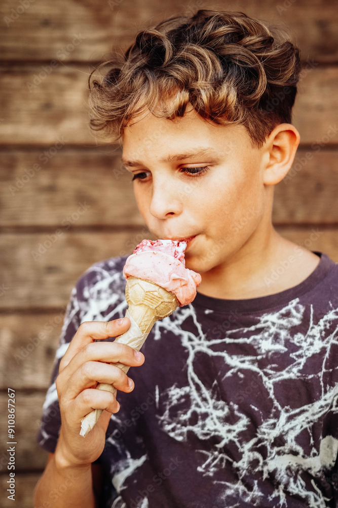 Boy eating delicious ice cream on a hot day
