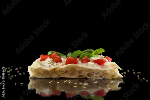 Italian pizza with mozzarella, tomatoes, basil and oregano on a black background