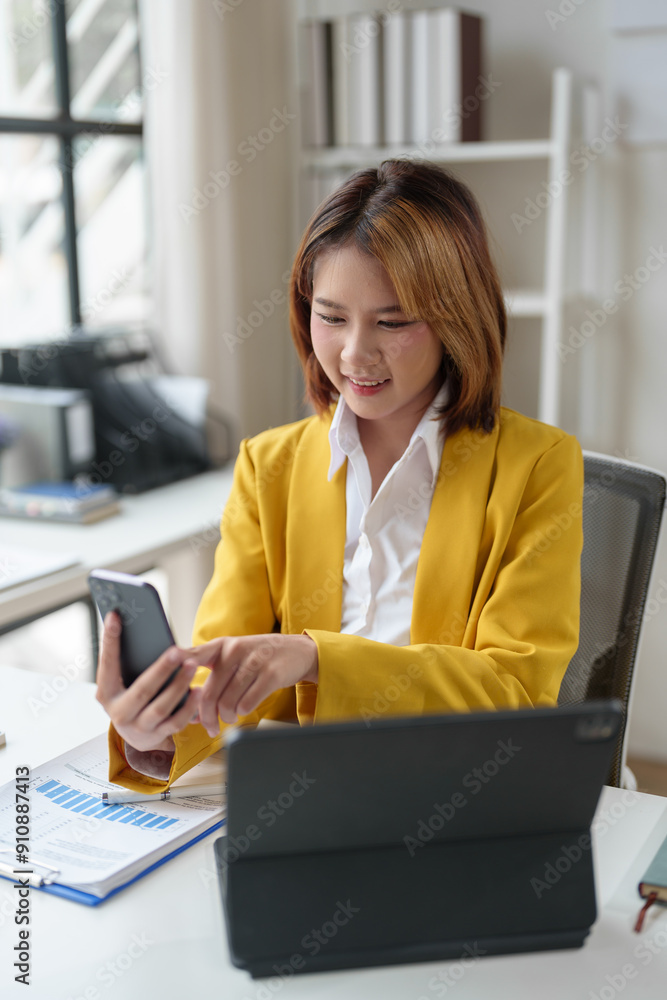 Attractive Asian business woman Use laptop to view computer and talk on mobile phone, contact financial business online. Conduct discussions and contact customers startup business idea. Attractive Asian business woman Use laptop to view computer and talk on mobile phone, contact financial business online. Conduct discussions and contact customers startup business idea.