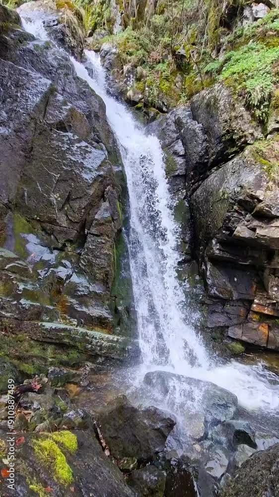 Spring time. Waterfall in the mountains with a lot of rocks around Spring time. Waterfall in the mountains with a lot of rocks around