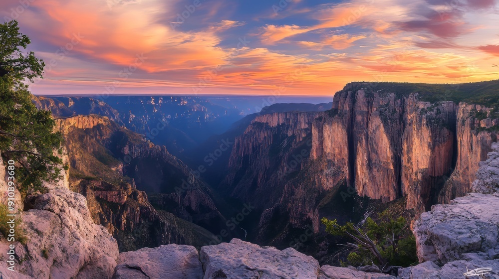 Panoramic View of Rugged Mountain Landscape at Sunset, Dramatic Cliffs and Deep Gorges with Sky Ablaze in Warm Hues of Orange and Pink Panoramic View of Rugged Mountain Landscape at Sunset, Dramatic Cliffs and Deep Gorges with Sky Ablaze in Warm Hues of Orange and Pink