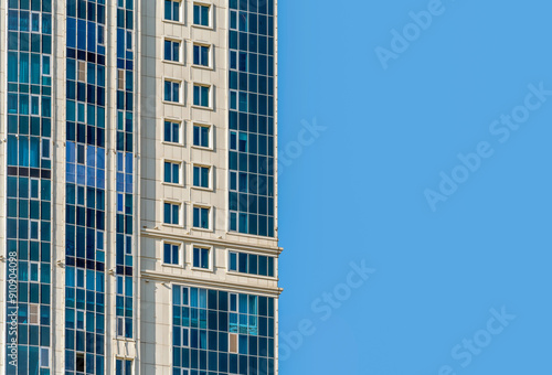 many windows and walls facade of a modern skyscraper without people