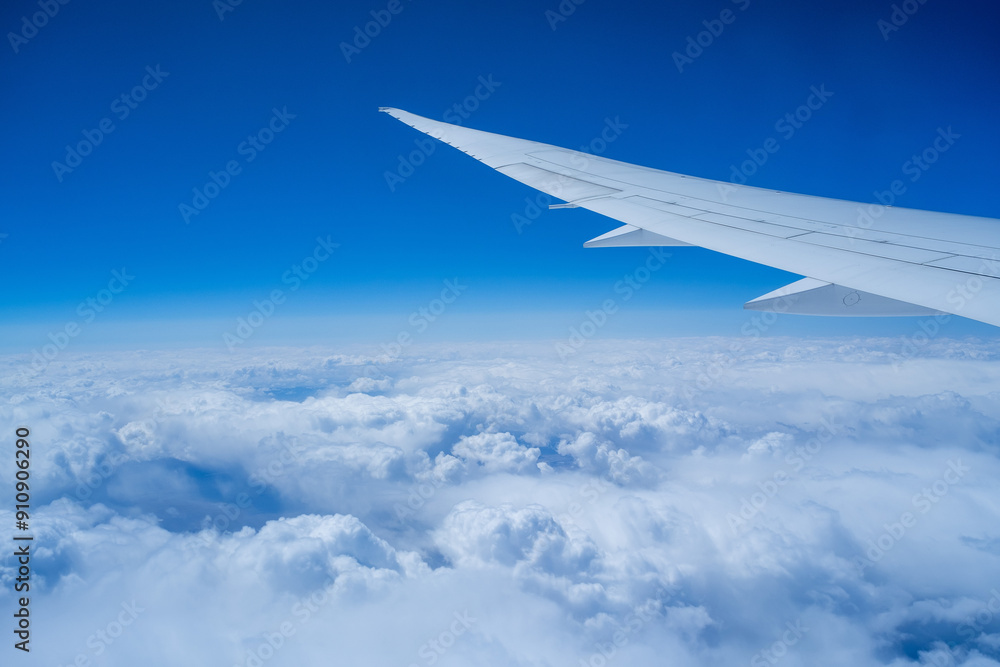Fototapeta premium View from an airplane on a blue sky and white clouds