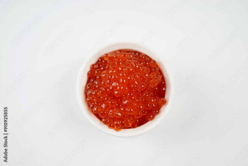 Salmon Red Caviar. Red fish caviar in white bowl. Raw seafood. Luxury delicacy food. White background. Salmon Red Caviar. Red fish caviar in white bowl. Raw seafood. Luxury delicacy food. White background.
