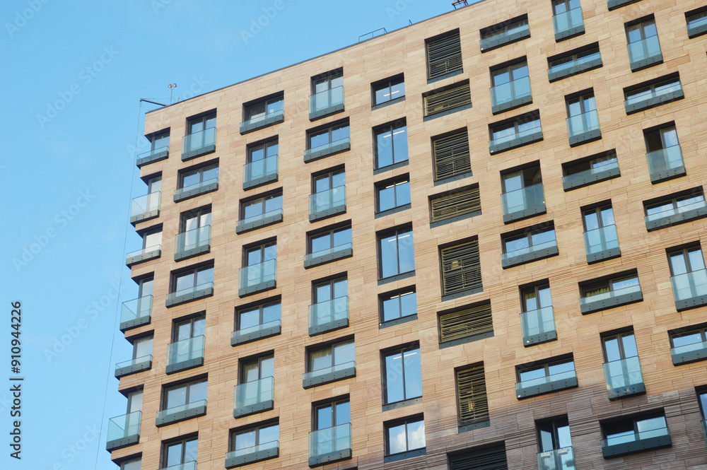 Multi-storey modern brick residential building. Building facade. Urban architecture. Multi-storey modern brick residential building. Building facade. Urban architecture.