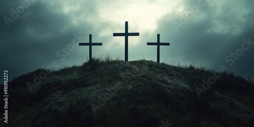 Three crosses on hill under clouds
