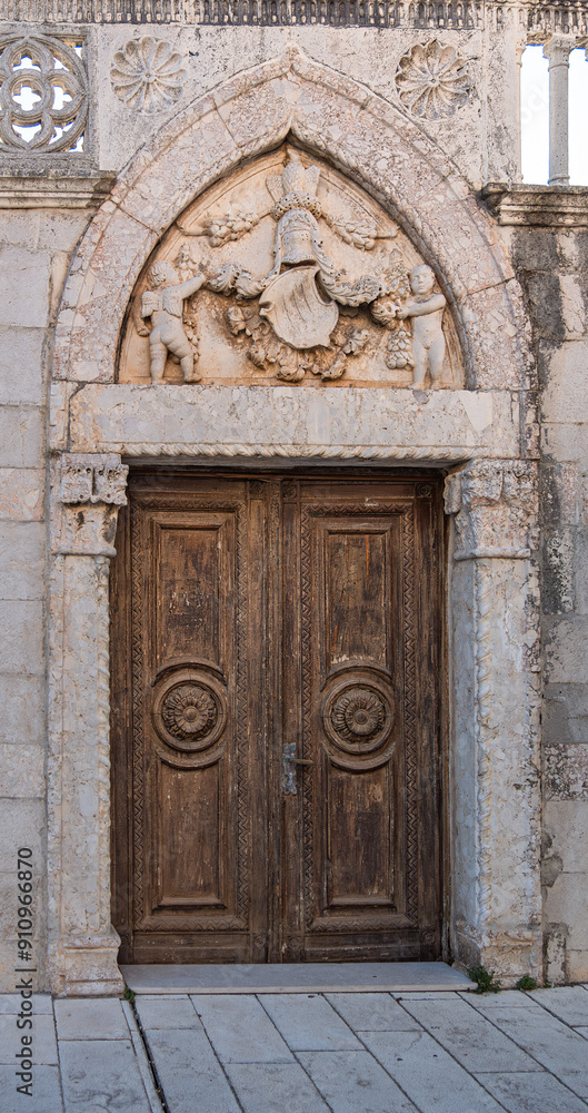 A historic wooden door in a stone archway A historic wooden door in a stone archway