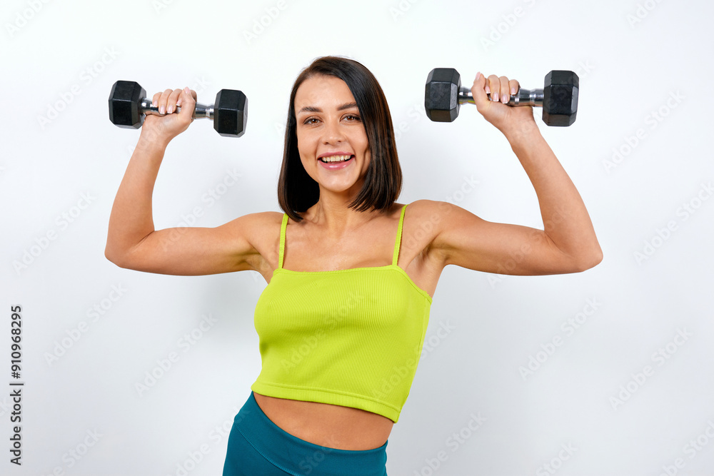 Brunette woman advertising exercise with dumbbells Brunette woman advertising exercise with dumbbells