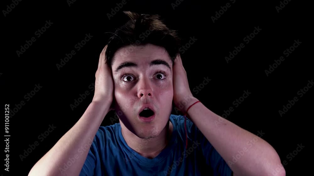 Shocked, terrified young man isolated on black background. Shocked, terrified young man isolated on black background.