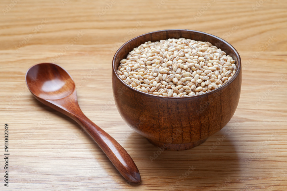 Peeled barley in a wooden bowl on the table Peeled barley in a wooden bowl on the table