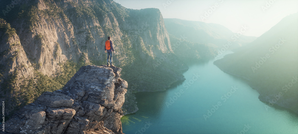 Naklejka premium Hiker on mountain peak watching river flow through rocks.