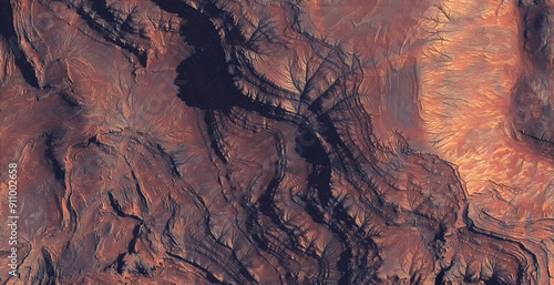 Foto Aerial view of reddish canyon with rugged cliffs.