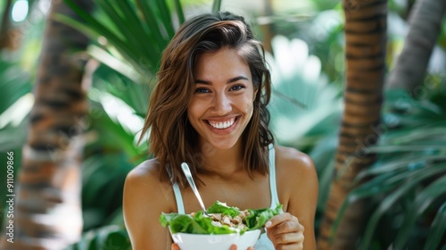 The cheerful woman with salad photo