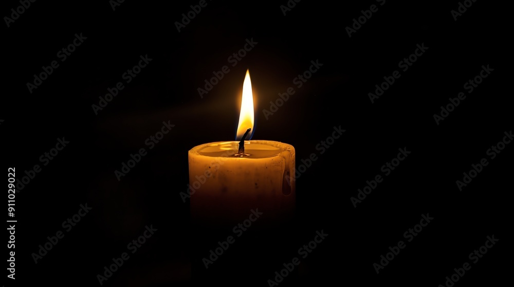 A single candle flame illuminates the darkness. A single candle flame illuminates the darkness.