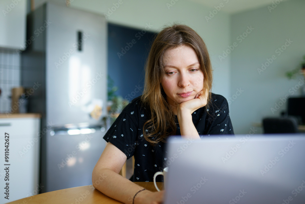 Freelancer working on laptop at table Freelancer working on laptop at table