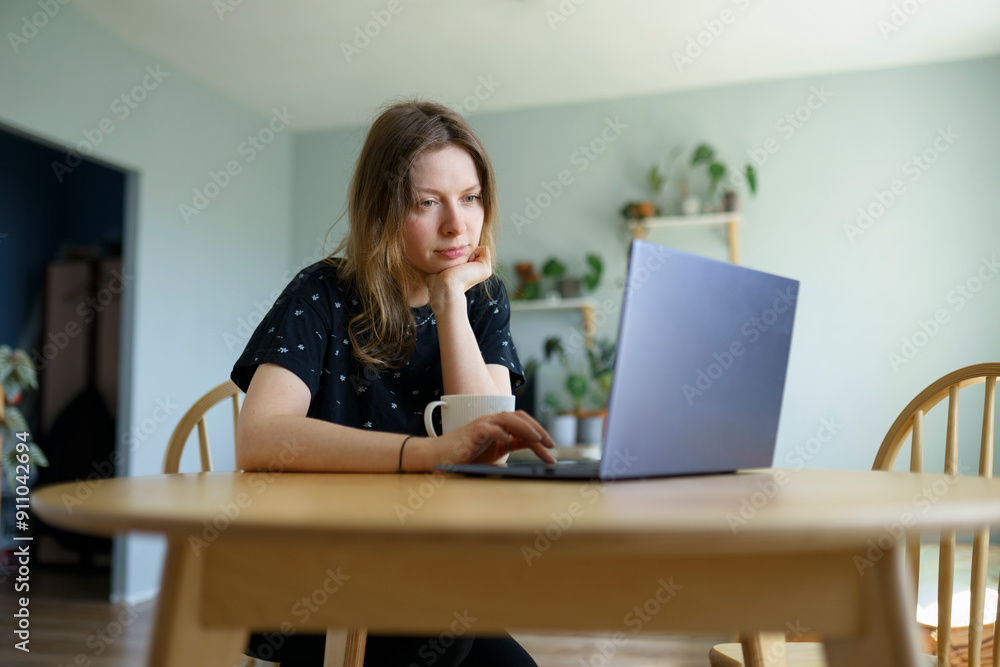 Freelancer working on laptop in home Freelancer working on laptop in home