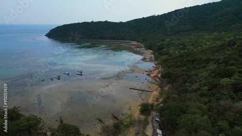 aerial view of a low tide beach with fishing boats moored at the sand in the famous Karimunjava (Karimun Jawa) island, Central Java, Jepara - Indonesia photo