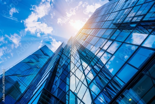 Modern office building with blue sky and glass facade  depicting the concept of economy and finance from a bottom-up view  with a blurred background.