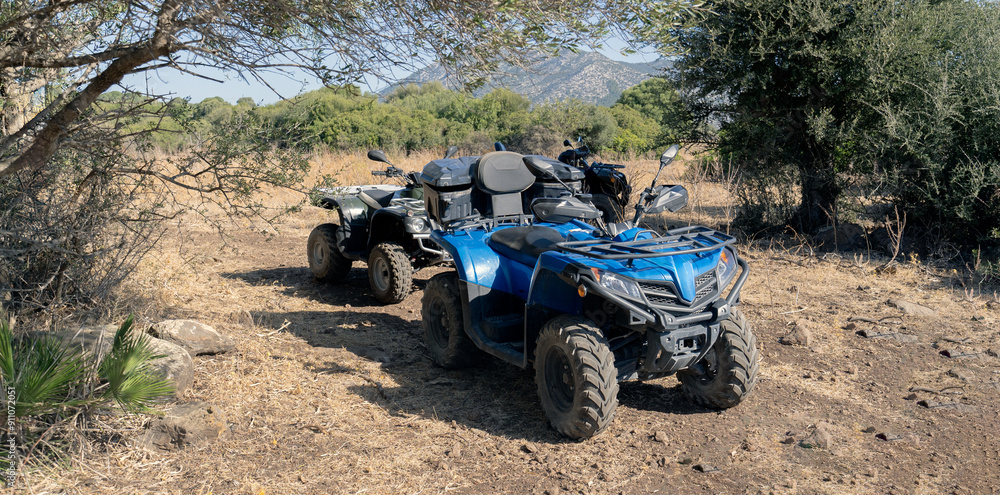Two-seater quad bikes and passengers take a break from their safari in Dorgali in central Sardinia Two-seater quad bikes and passengers take a break from their safari in Dorgali in central Sardinia