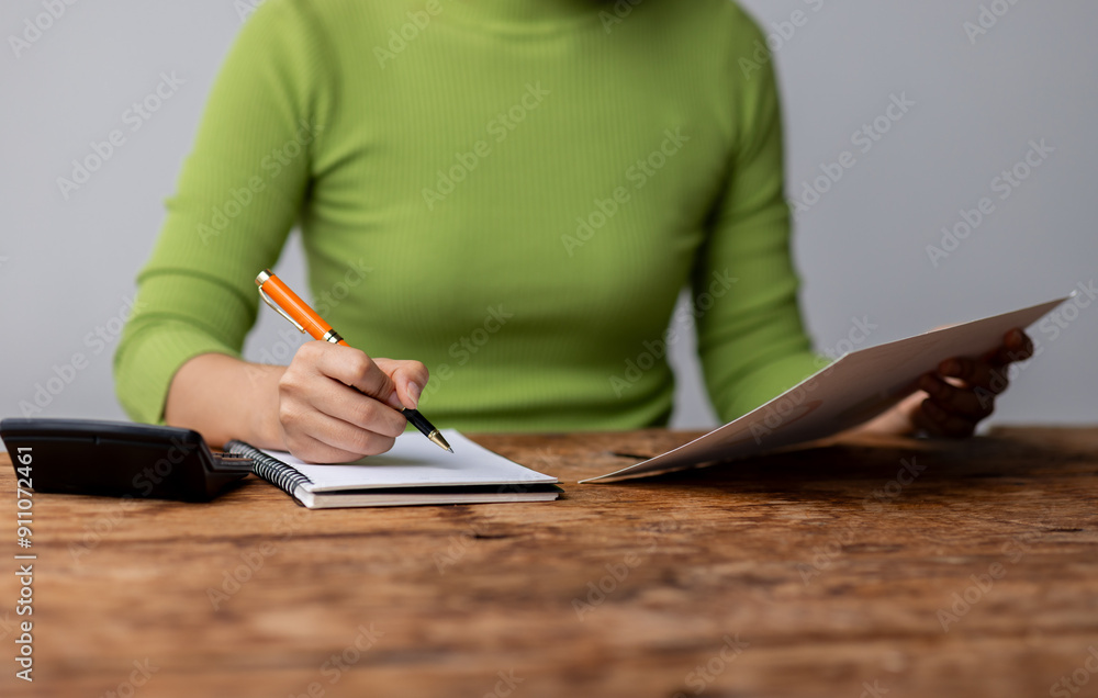Woman accountant use calculator and computer with holding financial graph data analysis and project management concept, Woman accountant use calculator and computer with holding financial graph data analysis and project management concept,