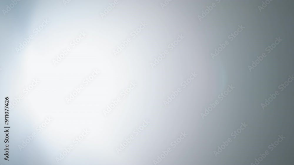 Intense studio spotlight shining brightly in a dark room, casting a focused beam of light against a foggy background Intense studio spotlight shining brightly in a dark room, casting a focused beam of light against a foggy background
