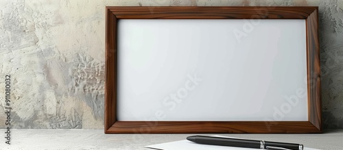 Beautiful wooden picture frame with an office symbol set on a white paper background with a black pen nearby Business focused with copy space image
