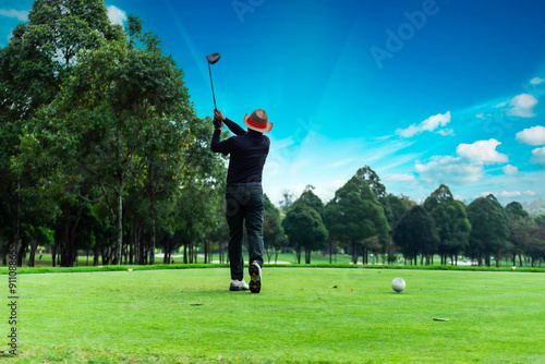 Golfer driver back swing before hitting golf ball down the fairway.