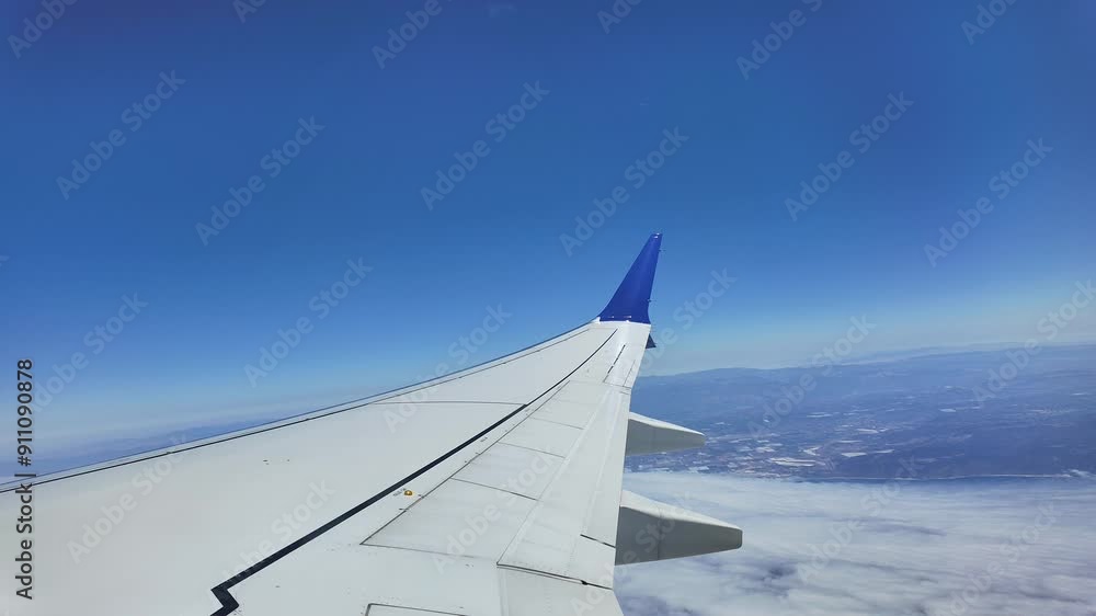 Timelapse of airplane wing view flying over light clouds Timelapse of airplane wing view flying over light clouds