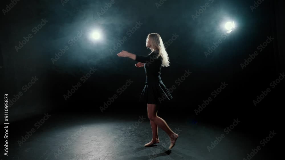 Modern ballerina dancing in darkness, graceful lady jumping, slow motion. Talented female dancer rehearsing contemporary choreography in dark dance class, silhouette of pretty slender lady in black Modern ballerina dancing in darkness, graceful lady jumping, slow motion. Talented female dancer rehearsing contemporary choreography in dark dance class, silhouette of pretty slender lady in black
