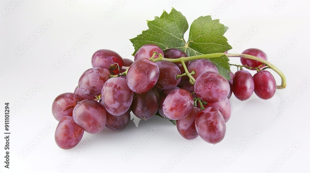 Fototapeta premium Branch of Grapes on a Table Against a White Background