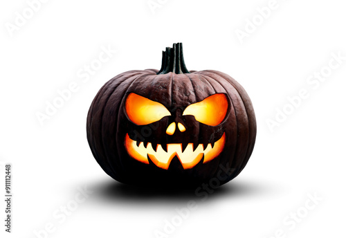 Obraz na płótnie A halloween pumpkin carved lantern at night with a scary, spooky evil glowing face isolated against a transparent background for use on dark backgrounds. w salonie
