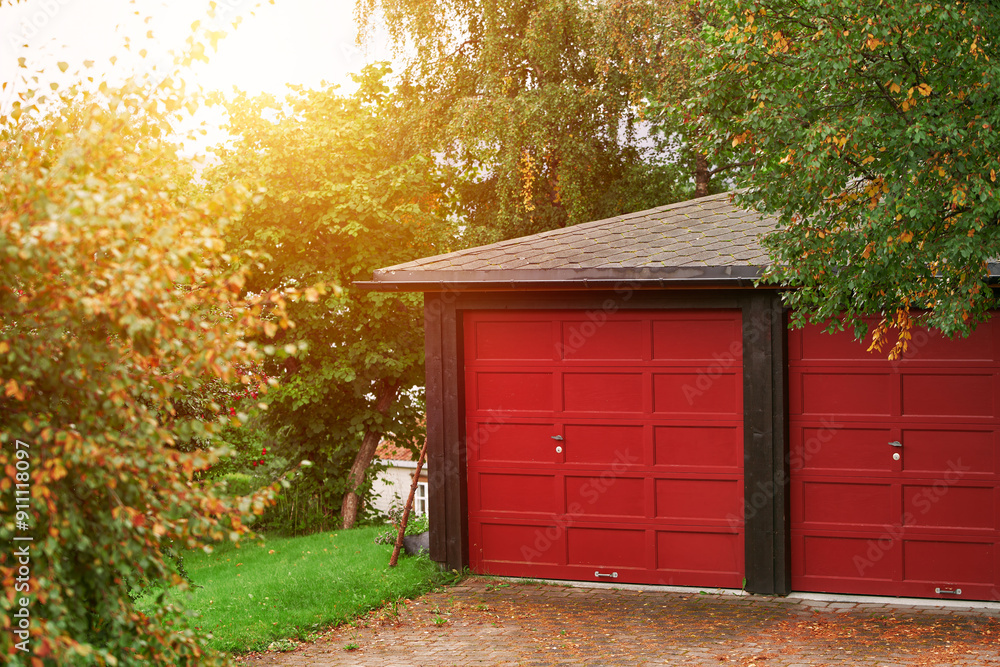 Wooden garage doors with house in view Wooden garage doors with house in view