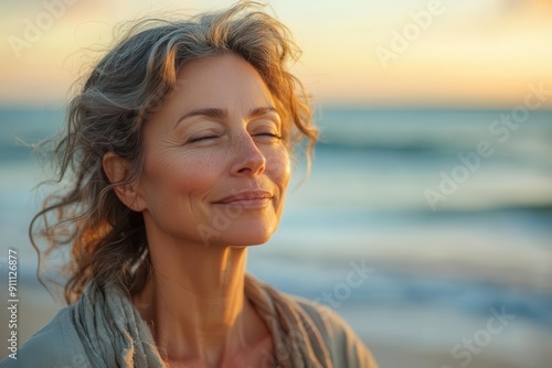 serene coastal scene with a radiant middleaged woman basking in golden hour light soft waves and warm sand frame her content expression embodying peace and selfacceptance