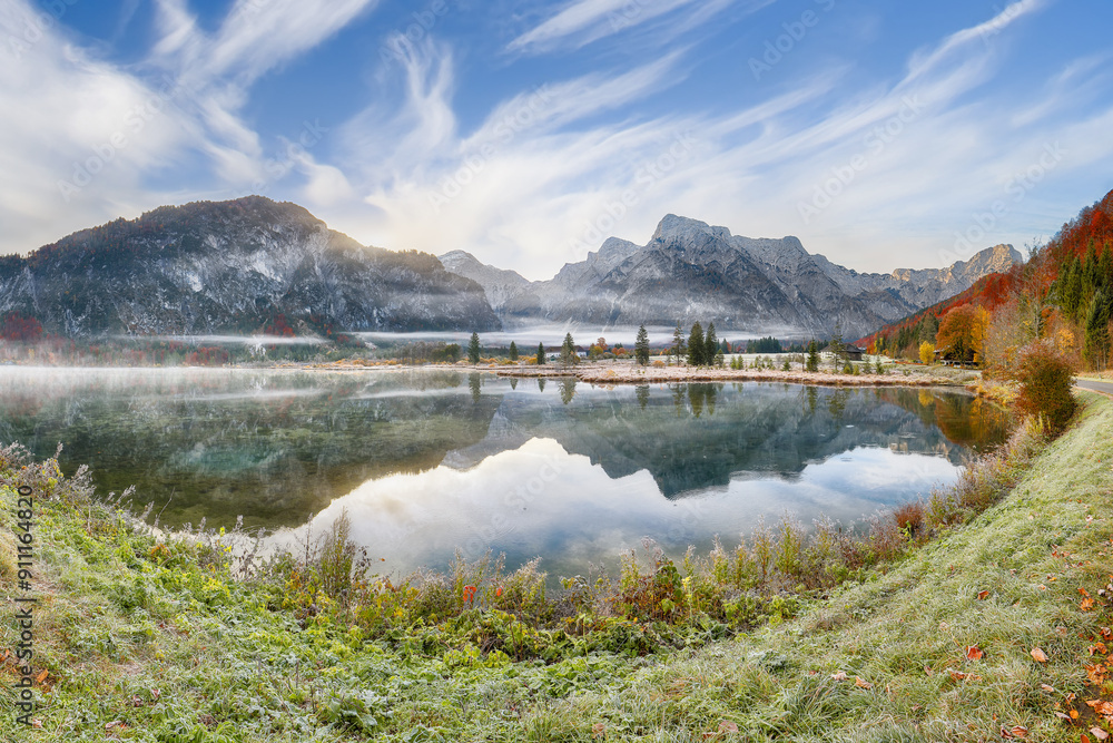 Captivating autumn scene of foggy and sunny morning on Almsee lake.