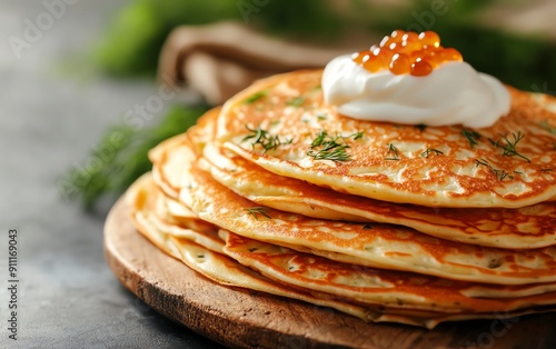 A colorful array of Russian blini pancakes stacked high, served with various toppings like sour cream, caviar, and dill, on a rustic wooden board with traditional Russian textiles photo