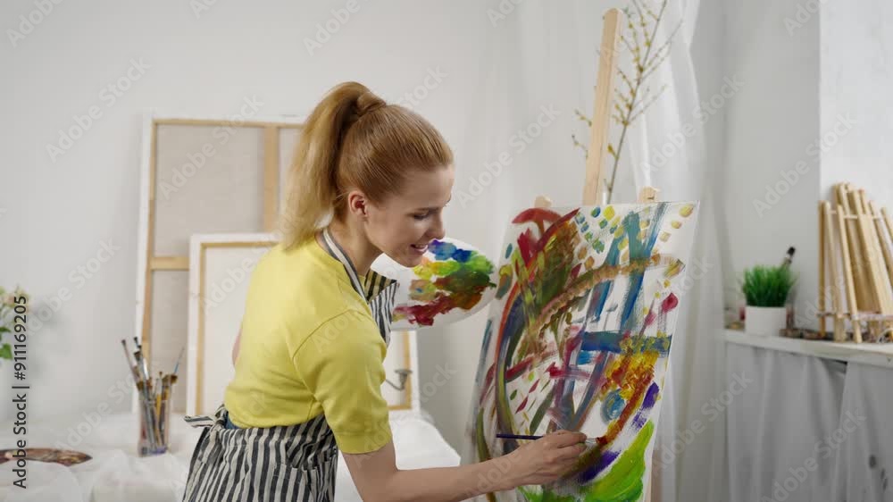 Female student of school of arts drawing abstract picture on canvas in ...