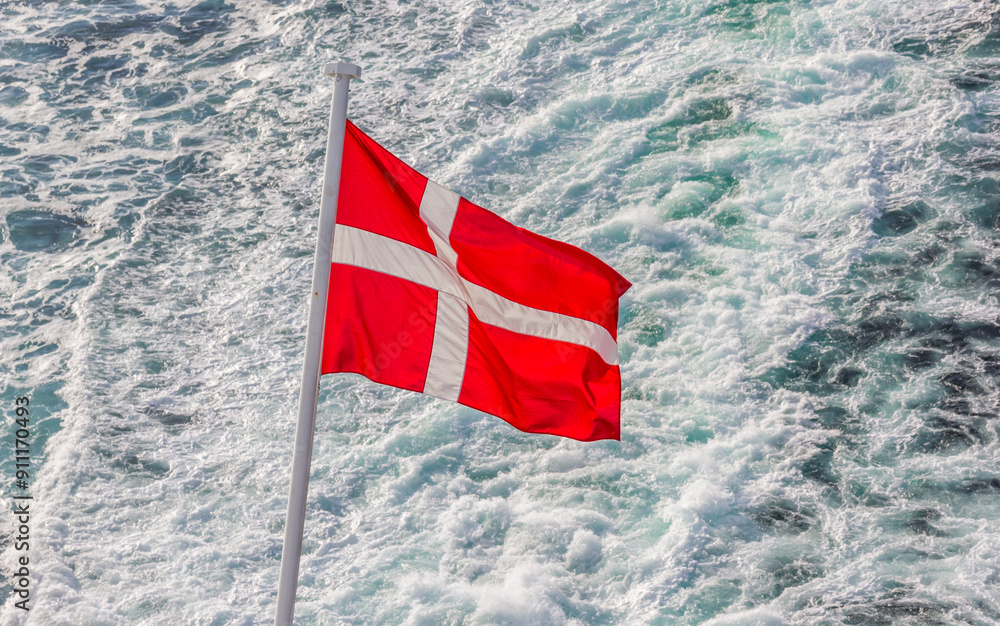 Danish flag on the back of a cruiseship sailing on the North Sea