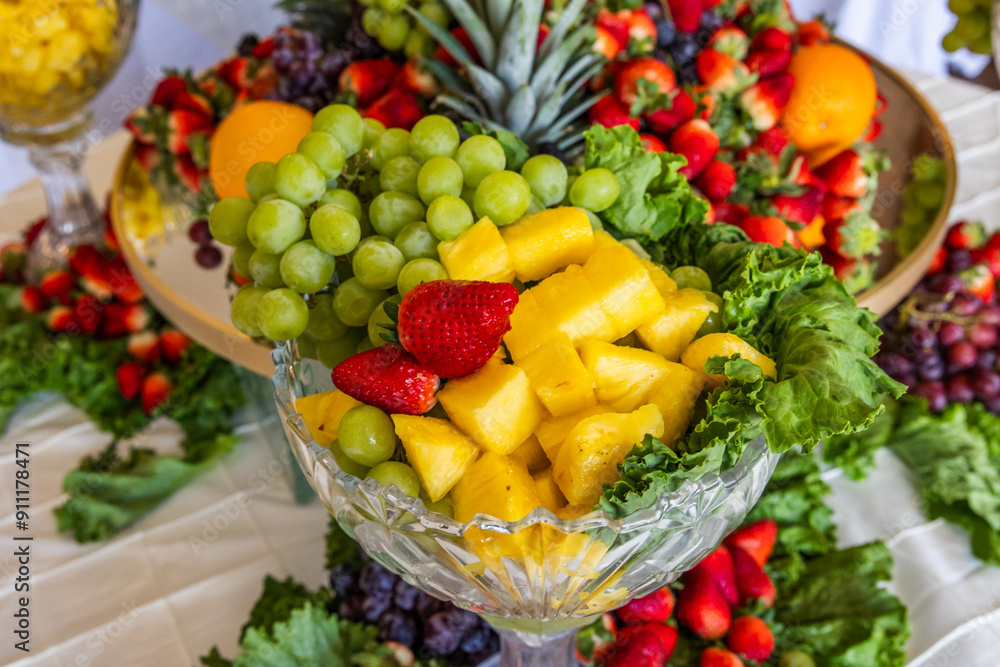 Fresh raw organic summer berries and exotic fruits in round large tray on black kitchen background. Papaya, grapes, nectarine, orange, raspberry, kiwi, strawberry, lychees, cherry. Top view Fresh raw organic summer berries and exotic fruits in round large tray on black kitchen background. Papaya, grapes, nectarine, orange, raspberry, kiwi, strawberry, lychees, cherry. Top view