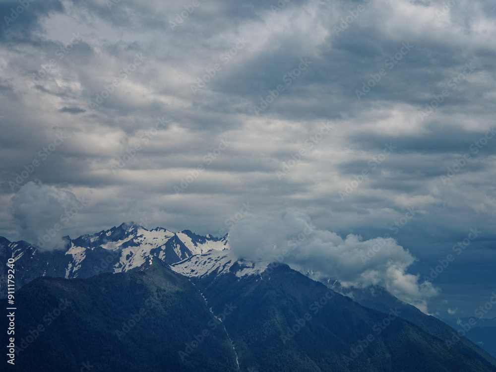 Green mountains, shrouded in clouds and fog, create a mysterious atmosphere and a fascinating view of nature Green mountains, shrouded in clouds and fog, create a mysterious atmosphere and a fascinating view of nature