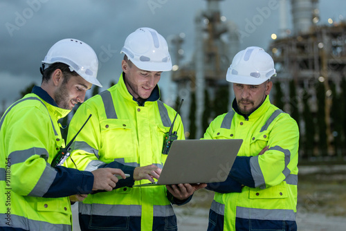 Bild auf Leinwand Team professional electrical engineer safety uniform working together power plant or station refining oil petrochemical using laptop evening