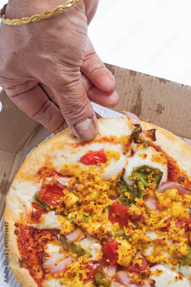 Pizza with paneer and cheese in a cardboard box with the hands of a woman on a white background. Top view Pizza with paneer and cheese in a cardboard box with the hands of a woman on a white background. Top view